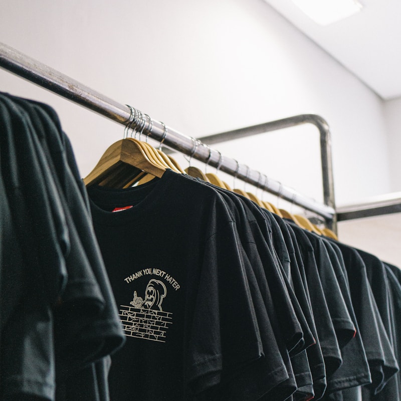 Rail of black printed t-shirts in a store