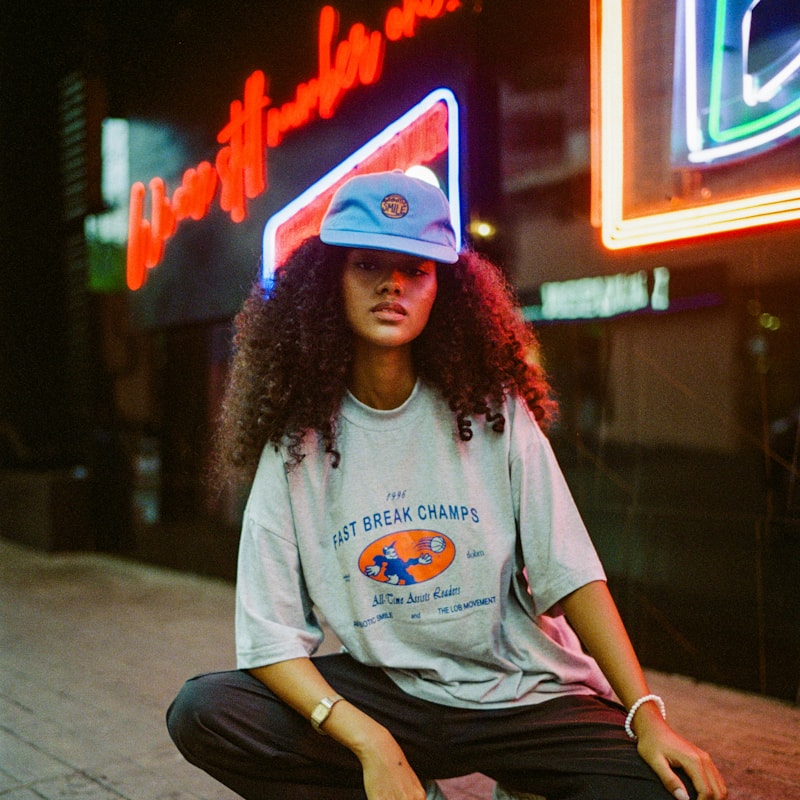 Person in a graphic t-shirt under neon street lights